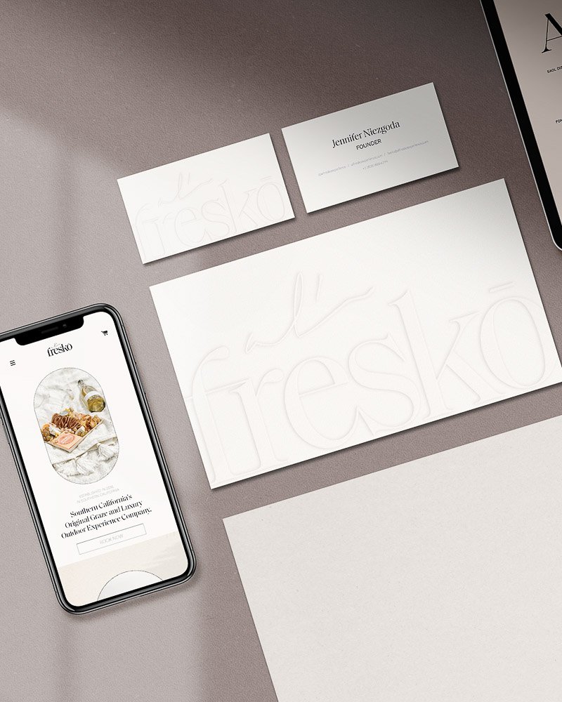 mockup of a phone, a website and stationary. Strategy, logo design, stationary design, web design and development.